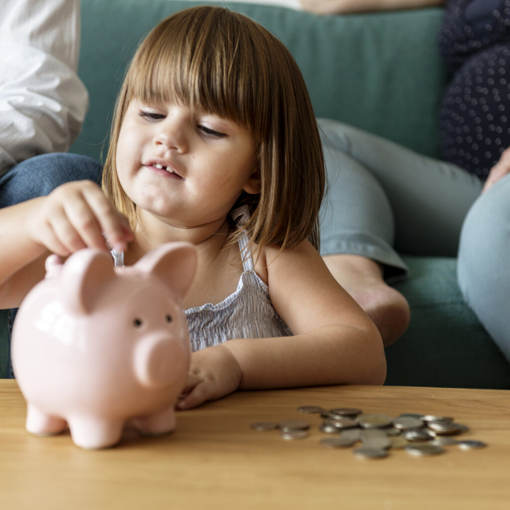 Family saving money in piggy bank