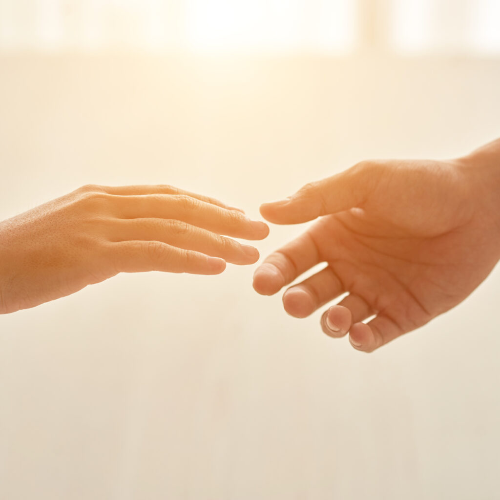 Hands of couple reaching for each other