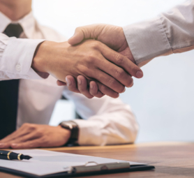 Real estate broker agent and customer shaking hands after signing contract documents for realty purchase, Bank employees congratulate, Concept mortgage loan approval.